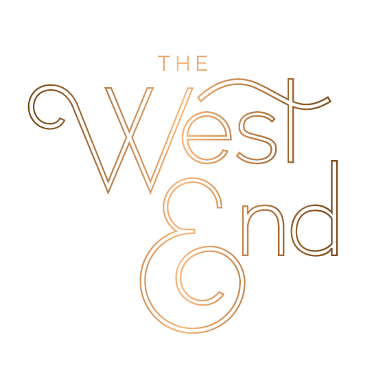 “The West End” logo in thin, stylized serif lettering with flowing accents, rendered in a warm gold gradient on a white background.